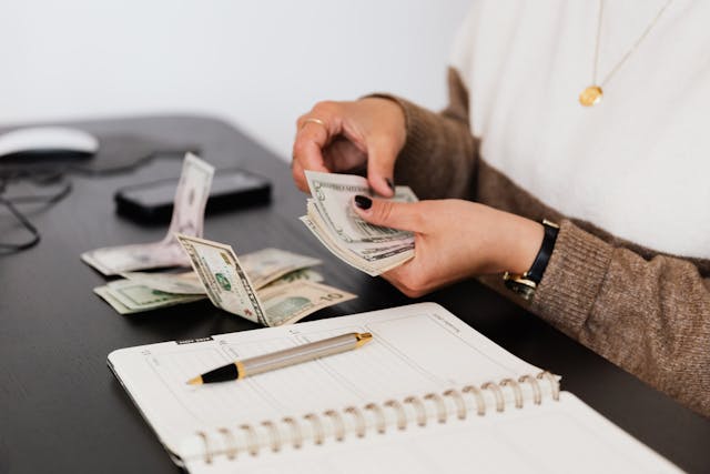pexels-karola-g-4475523 person-counting-money-on-table