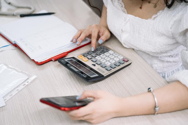 pexels-anntarazevich-5196820 person-on-calculator-with-notebook