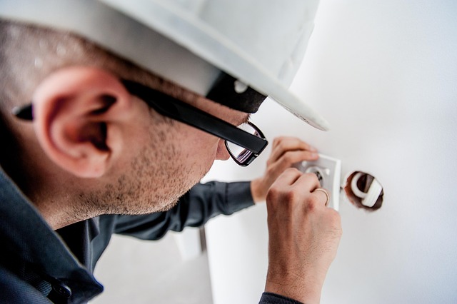 person-fixing-wall-socket person-fixing-wall-socket