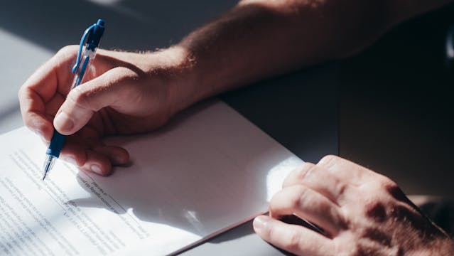 person-signing-documentation person-signing-documentation
