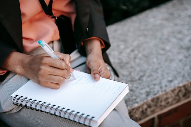 person-writing-in-notebook person-writing-in-notebook