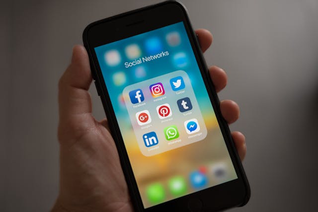 pexels-tracy-le-blanc-67789-607812 a phone with social media apps, held in a hand